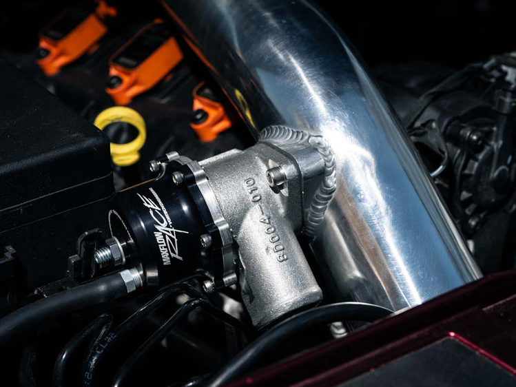 Close-up of the RIPP supercharger system installation in a vehicle, emphasizing seamless compatibility